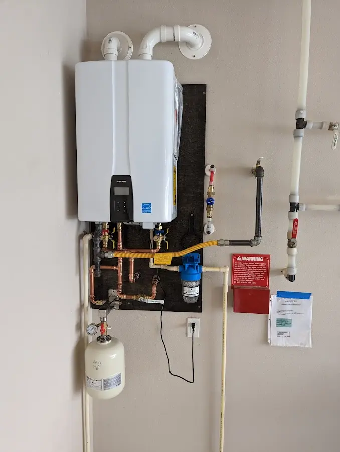 Professional plumber installing copper piping in a Parkville home